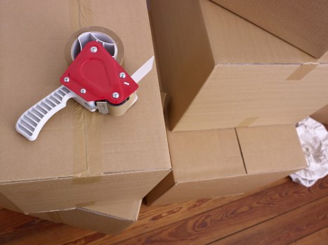 A staged business relocation setup with labelled boxes and office furniture