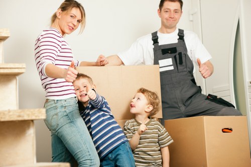 Packed boxes and furniture ready for a moving truck in Edgware